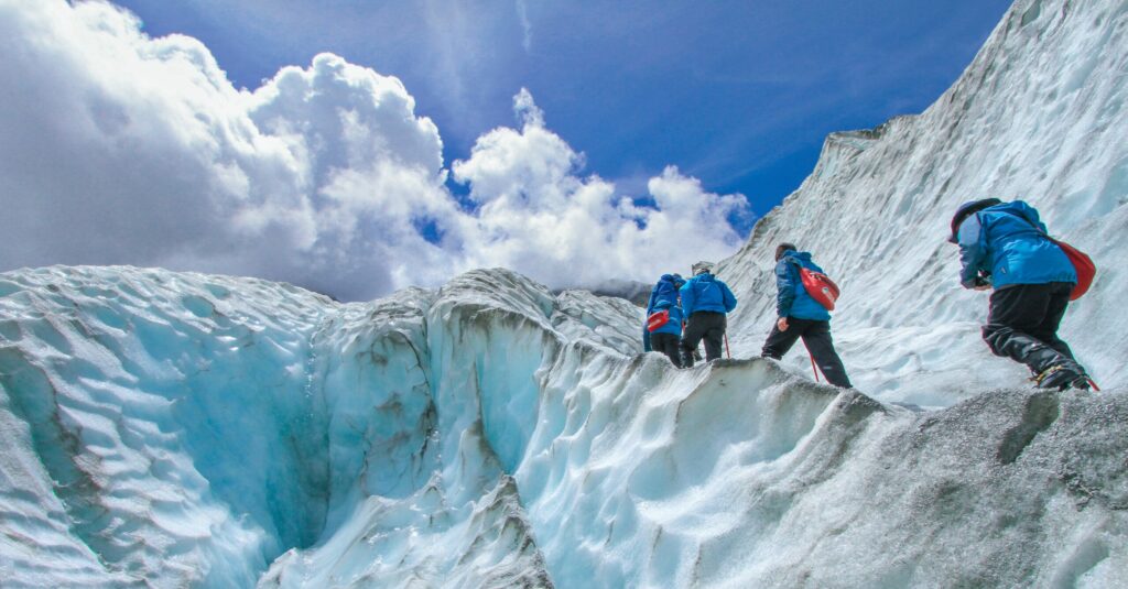 Team climbing up an icy mountain